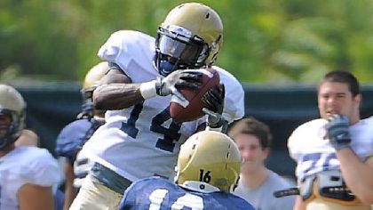 Greg Cross goes up to pull in a 23-yard pass in front of Kolby Gray in Saturday's scrimmage.