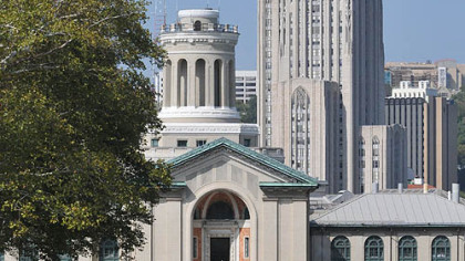 The University of Pittsburgh's Cathedral of Learning looms over Carnegie Mellon University's Hamerschlag Hall.