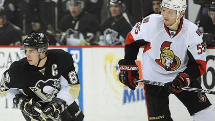 Penguins captain Sidney Crosby skates with Senators defenseman and former teammate Sergei Gonchar.