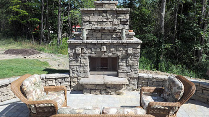 An outdoor fireplace built with Belvedere concrete blocks by OmniPro at the Cranberry home of Dan Smith and Don Megahan.