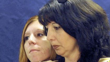 Sisters of the late Jerry Lee Cushey Jr., Gina Thorn, left, of Fairmont, W.Va., and Sonya Helmantoler, of Monongahela, listen as Washington County District Attorney Steven Toprani talks about the arrests in the killing of their brother.