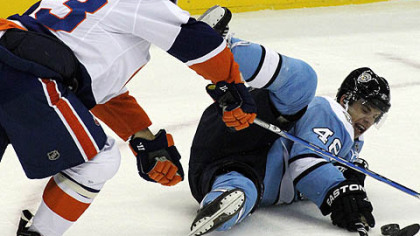Penguins forward Tyler Kennedy collides with Islanders forward Doug Weight during the first period.