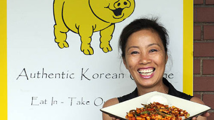 Yong Kwon, owner/chef at the Golden Pig in Cecil, presents one of her menu items-- oh jing uh bockeum (spicy squid that is broiled and seasoned).