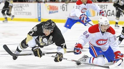 The Canadiens' Tom Pyatt trips Evgeni Malkin in the third period Saturday.
