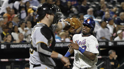 The Mets' Jose Reyes races home to score on Angel Pagan's second-inning double, as Pirates catcher Chris Snyder waits for the throw.