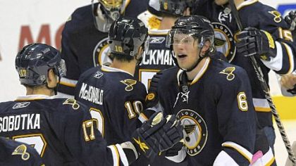 St. Louis' Erik Johnson is congratulated by teammates after scoring the winner.