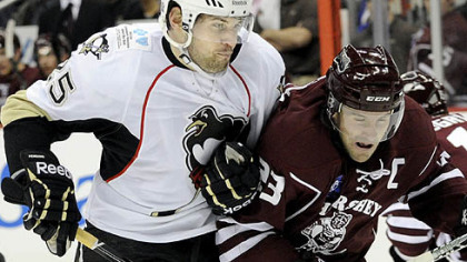 Eric Tangradi puts a hit on Hershey's Andrew Joudrey last night at Consol Energy Center.