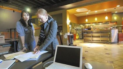 Jennifer Jin, the manager of David Racicot's new restaurant Notion, goes over the original floorplans Jen Bee.