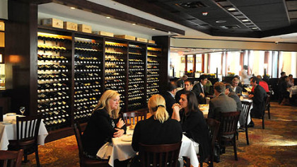 At The Carlton, Downtown, the wine library, where diners can browse and select a bottle, is at left.