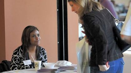 Kerri Boatwright, right, of Cranberry speaks with Michele Troutman of Gwen's Girls at the Orphan Care Expo at Northway Christian Community in Pine on Saturday.