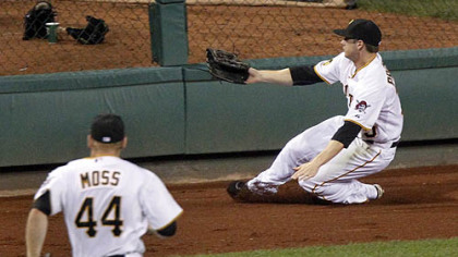 Pirates center fielder Alexander Presley slides on the warning track as he chases a fly ball that went for a double by Cardinals pinch-hitter Nick Stavinoha in the ninth inning. Left fielder Brandon Moss give chase.