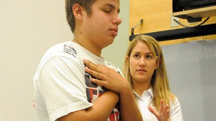 Physical therapy resident Pam Dunlap evaluates Gaige Pavlocak's balance