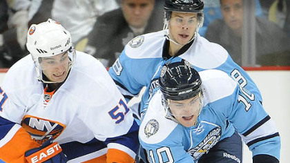 Penguins forward Mark Letestu fights for loose puck with Islanders forward Frans Nielsen in the first period.