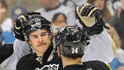 Penguins captain Sidney Crosby celebrates his second goal with teammate Chris Kunitz during Tuesday's game against the Thrashers in the first period at Consol Energy.