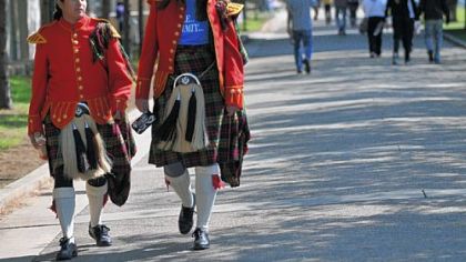 Kiltie Band members Alejandra Mendoza, left, of Philadelphia, and Agnes Marszalik, of Chicago, walk across the Carnegie Mellon campus on Saturday. Both play the clarinet.
