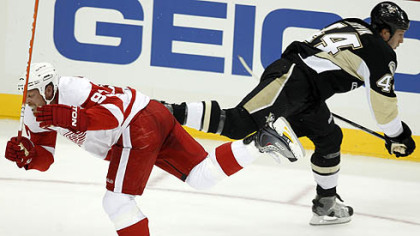 Red Wings forward Johan Franzencollides with Penguins defenseman Brooks Orpik in the first period. Franzen was helped off the ice after the collision.