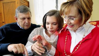 Russ and Robalee Bruesewitz use a use a DynaVox device to help communicate with daughter Hannah in their home in Mt. Lebanon.