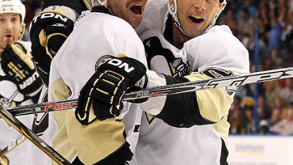 Penguins forward Craig Adams, right, congratulates teammate Pascal Dupuis on his first-period goal.