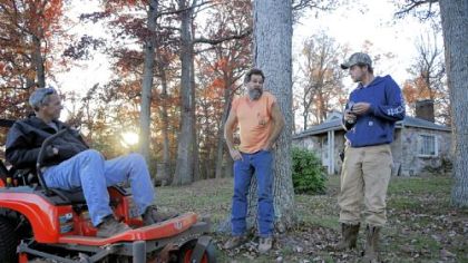 Derrick Earley, right, talks with his father, Rick Earley, left, and neighbor Steve Thomas near the Earley's home.