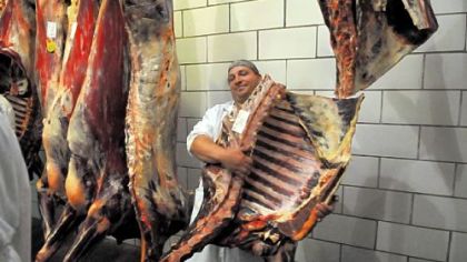 Jon Hollick muscles a side of beef out of the cooler for the butchery class.