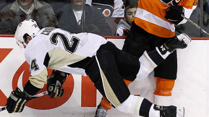 Penguins forward Matt Cooke goes flying after a collision with  Flyers forward Scott Hartnell in the first period of Tuesday's game at Wells Fargo Center in Philadelphia.