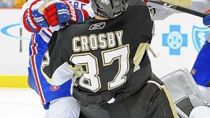 Former teammate Hal Gill of the Canadiens knocks Sidney Crosby off the puck in front of the Montreal net Saturday night at Consol Energy Center.