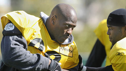 Steelers linebacker James Harrison, left, works against Sylvester Stevenson during drills at the team's afternoon practice Thursday.