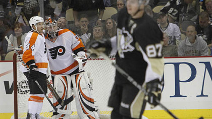 Flyers goaltender Sergei Bobrovsky celebrates with defenseman Kimmo Timonen as Penguins captain Sidney Crosby skates by.