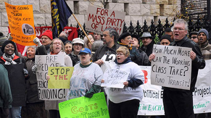People protesting cuts in public transit service gather on Wednesday along Sixth Avenue in Downtown Pittsburgh as the Port Authority board meets across the street to vote on the cuts.