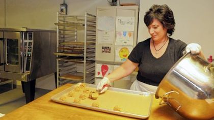 Caren Weaver scoops out batter for gluten-free, casein-free cinnamon macaroons in her bakery, Truly Wize, near Greensburg.