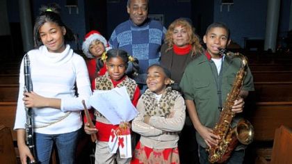 Dorothy Guy, back right center, and her husband Daniel Guy, back center, are raising five of their grandchildren, ages 7 to 12. The grandchildren are, left to right, Lisa White, 12; Israel White, 10; Egypt White, 8; Destiny Moletta, 7;  and Jonathan White, 12. Lisa and Jonathan are twins.