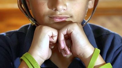 Jordan Brown, 11, a fourth-grader at South Lebanon Elementary School, wears his "Hang Tough" wristbands, at his home in South Lebanon Township.