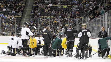 Penguins coach Dan Bylsma, right, talks to the team on ice during their first practice at the Consol Energy Center.