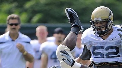 Running back Ray Graham is upended during Pitt's first full scrimmage of camp Saturday at its South Side practice facility.