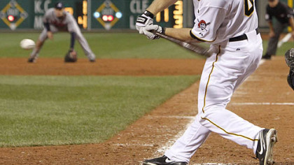 The Pirates' Brandon Moss gets an infield hit with the bases loaded to drive in run in the ninth inning.