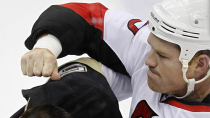 Penguins defenseman Deryk Engelland and Senators forward Chris Neil  fight during the first period.