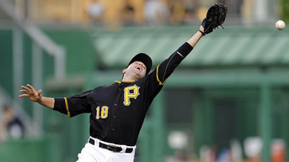 Pirates Neil Walker tries to grab a single hit by Mets David Wright.
