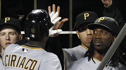 Pirates teammates greet Pedro Ciriaco, who scored in the ninth inning.