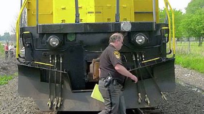 CSX rail workers and law enforcement officers look over a runaway freight train after it was stopped May 15, 2001, near Kenton, Ohio.