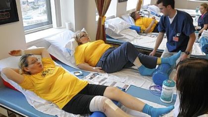 Debbie Wilson, left, 51, of Morgantown, W.Va., Susan Bates-Atallah, center, 62,  and Bill Simpson, back right, attend physical therapy the day after receiving knee replacements through the Operation Walk Pittsburgh program.