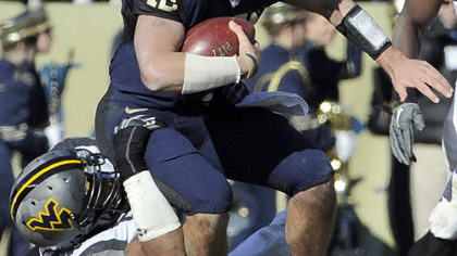 Pitt quarterback Tino Sunseri is sacked by WVU's Julian Miller.