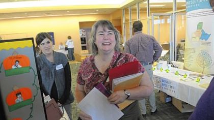 Sandra Wilson, center, of Rochester, a member of Northway Christian Church in Pine, talks during the Orphan Care Expo with Courtney Rademacher, left, and Russ McCurdy (barely visible), both of Project Star at the Children's Institute.