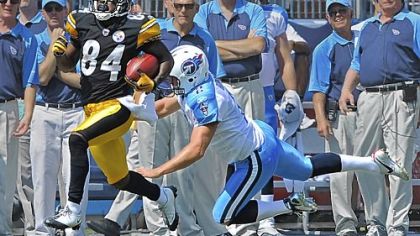 Antonio Brown gave the Steelers a quick lift, taking back the opening kickoff 89 yards. Tennessee kicker Rob Bironas makes one last attempt to bring him down.