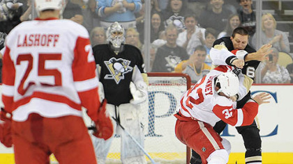 Penguins forward Jesse Boulerice throws a right to the head of Red Wings forwrd Aaron Downey.