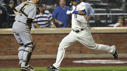 The Mets' Ruben Tejada scores the winning run in front of Pirates catcher Ryan Doumit on a single by Nick Evans in the 10th inning.