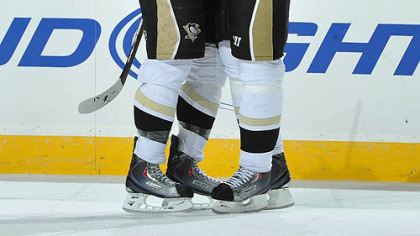 Penguins defenseman Alex Goligoski, left, is congratulated by forward Evgeni Malkin after scoring a goal during the first period.
