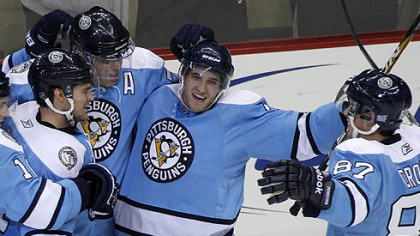 Penguins defenseman Alex Goligoski, center, celebrates his game-winning overtime goal with teammates Chris Kunitz, left, Evgeni Malkin, second from left and Sidney Crosby.