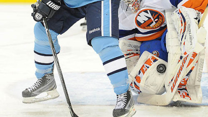 Penguins forward Matt Cooke fights for loose puck in front of Islanders goaltender Rick DiPietro in the first period.