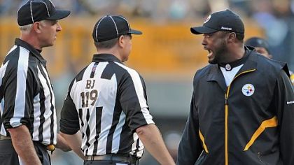 Steelers head coach Mike Tomlin has words with Greg Wilson, the back judge, and Gary Cavaletto, the field judge, during Sunday's game against Oakland.