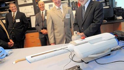 Federal Reserve chairman Ben Bernanke, right, checks out a snaking robot camera made by Cardiorobotics Inc. that's used in minimally invasive surgical procedures. Looking on in South Oakland are three company executives, from left to right, CEO Samuel Straface, vice president Kevin Gilmartin and director of clinical application Richard Kuenzler.